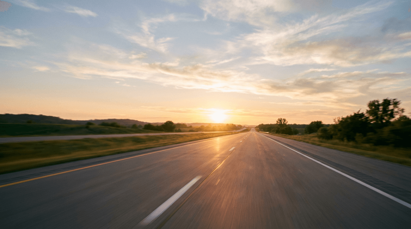 Car driving on highway with city skyline in the distance